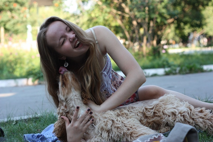 Woman happy given some cuddles on her dog
