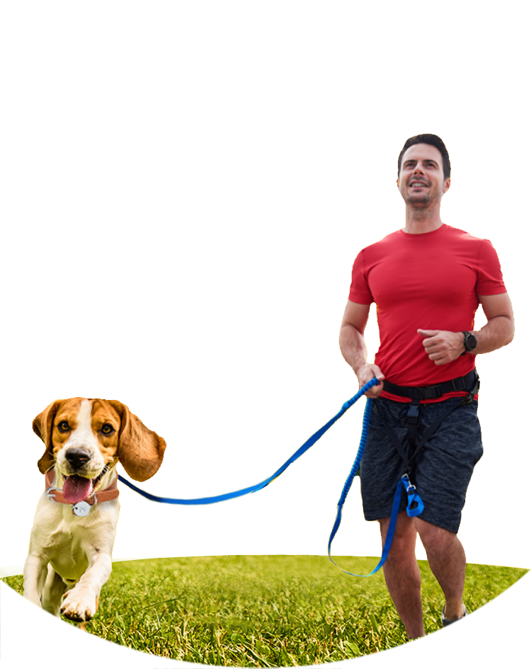 a man wearing a red shirt running with his brown and white American Foxhound